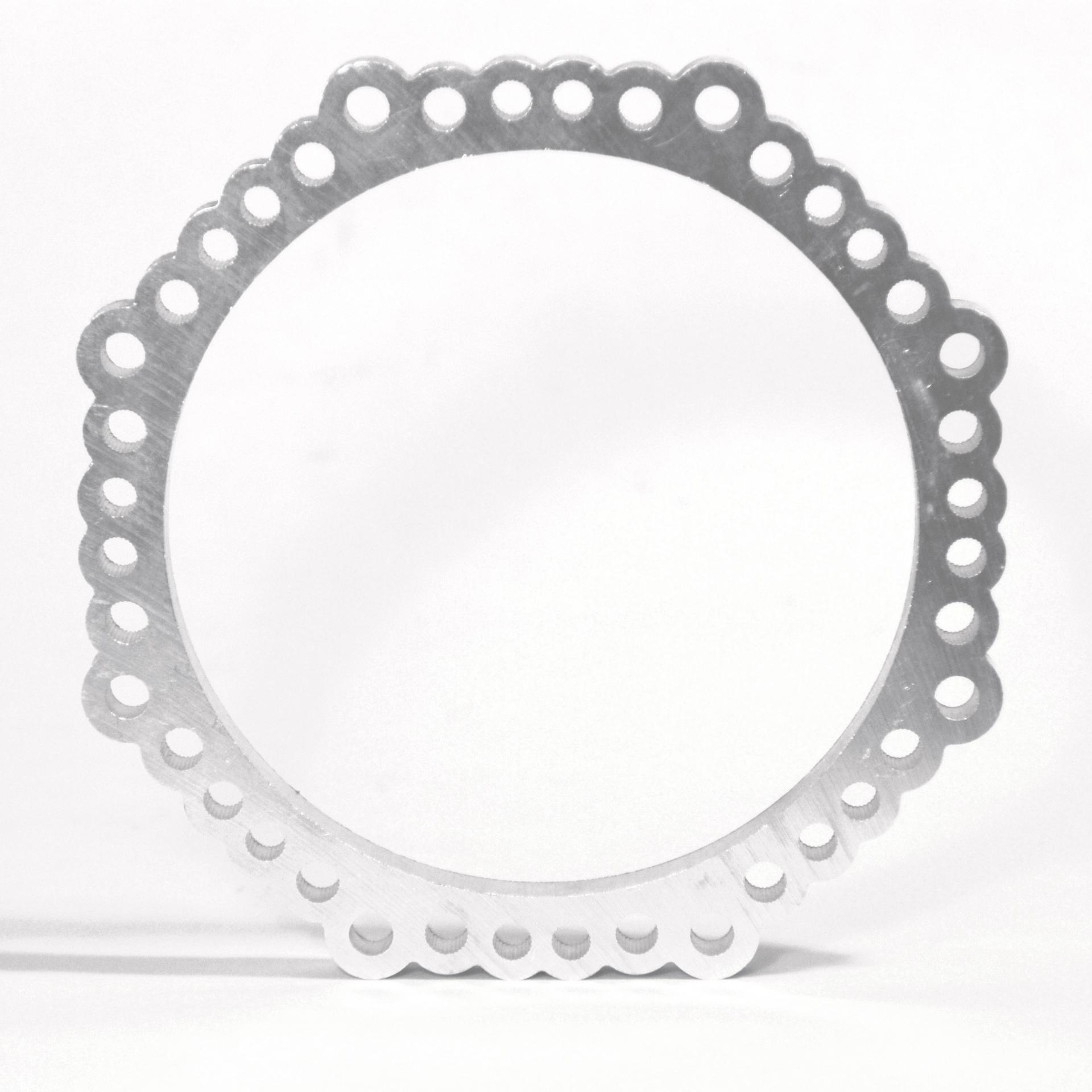 Round aluminum piece used as a fitting for an ice maker